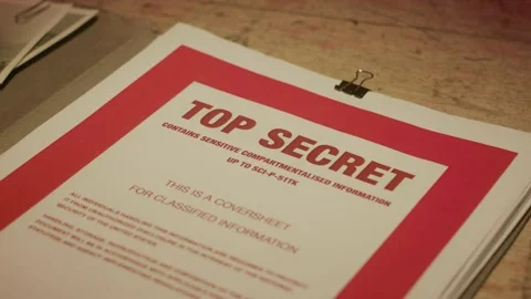 A manilla folder containing 'Top Secret' documents is lit by subdued light Stock Footage 233327859