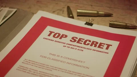 A manilla folder containing 'Top Secret' documents is lit by subdued light Stock Footage 233327861