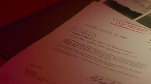 A manilla folder containing 'Top Secret' documents is lit by subdued light Stock Footage 233328365