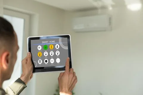 Manipulating air conditioner with tablet Stock Photos