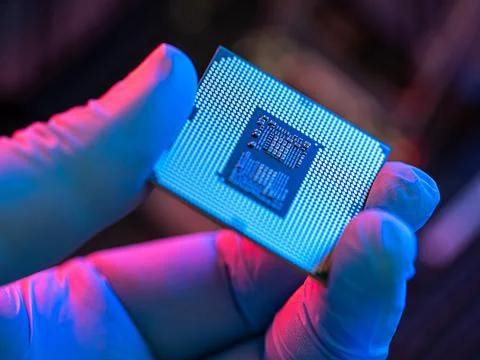 Manipulating and installing processor on the motherboard in details with blur Foto stock