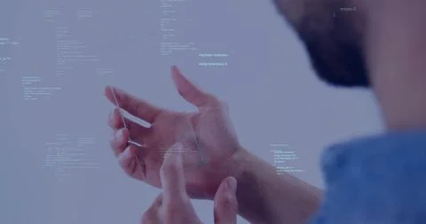 Manipulating male developer hands tapping glass panel in studio, wearing blue Foto stock