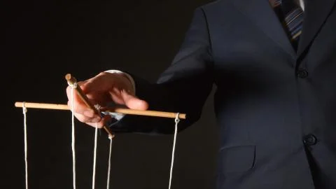 MANIPULATION: Businessman manipulating Stock Photos
