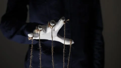 Manipulator hands in white gloves with ropes on fingers Stock Footage 253371376
