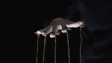 Manipulator hands in white gloves with ropes on fingers Stock Footage 253371379