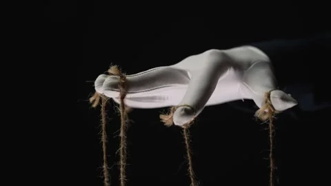 Manipulator hands in white gloves with ropes on fingers Stock Footage 253371976