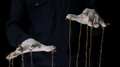 Manipulator hands in white gloves with ropes on fingers Stock Footage 253373228