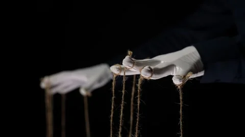 Manipulator hands in white gloves with ropes on fingers Stock Footage 253374139