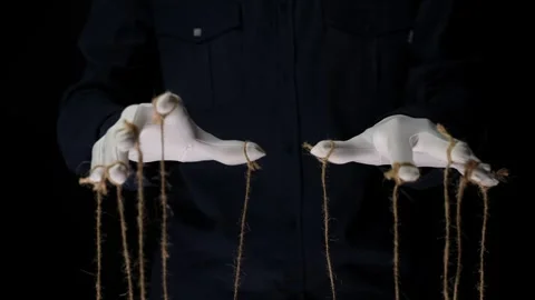 Manipulator hands in white gloves with ropes on fingers Video stock 253601946