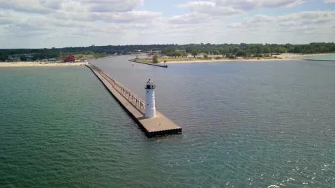 Manistee North Pier Lighthouse at Lake Michigan shore in Manistee, Western .. Stock Footage 235554591