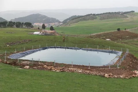 The manmade pool for agriculture by using plastic sheet Stock Photos