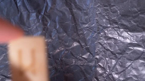 Mannaz inverted rune. close-up, hand puts the rune on the surface for divination Stock Footage 87880638