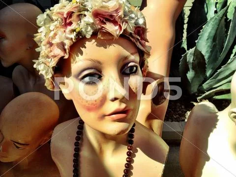 Mannequin bust wearing flowers and necklace Stock Photos