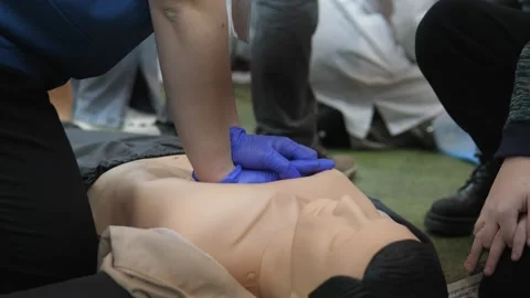 Mannequin CPR training with supervision, Participant performing continuous 스톡 동영상 324683614