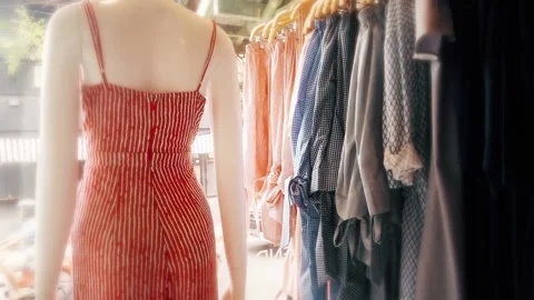 A mannequin in a designer store next to the rack of clothes Stock Footage 168185335