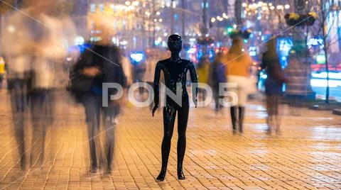 The mannequin standing on the crowd street. evening time Stock Photos