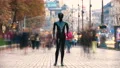 The mannequin standing in a people crowd on the street. time lapse 4k or 4k+ Resolution