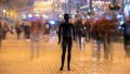 The mannequin standing in a people stream in the evening street. time lapse 4k or 4k+ Resolution