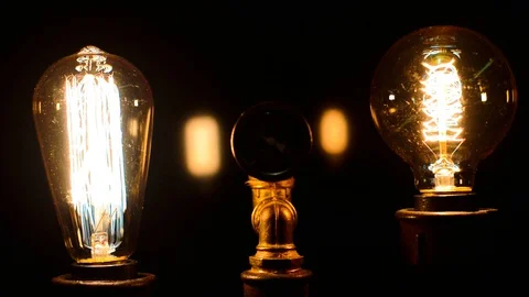 Manometer between two decorative filament light bulbs is on and slowly fades out Stock-Footage 127886408