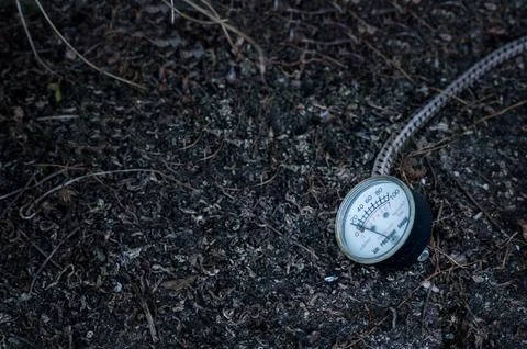 Manometer clock on dark earth Stock Photos