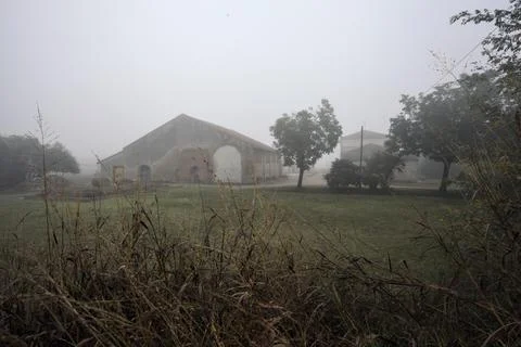 Manor and its barn with trees on a foggy day in the italian countryside in .. Stock Photos