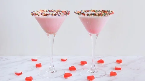Man's and woman's hands taking pink milk cocktail, close-up. Decorated with Video stock 71692220