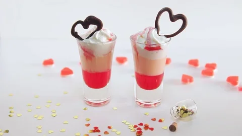 Man's and woman's hands taking multi-layered cocktail shot and than putting it Stock Footage 71694944