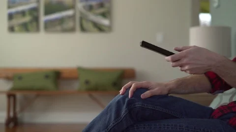Mans arm as he is changing channels on TV Stock Footage 72608039