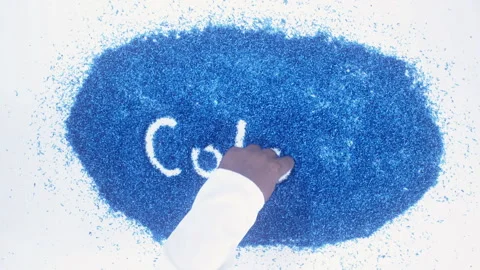 Man's arm writing in the blue particles the word Colours Video stock 248538309