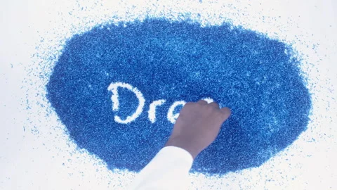 Man's arm writing in the blue particles the word Dress Stock Footage 248538419