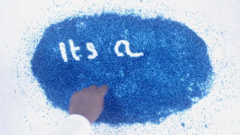 Man's arm writing in the blue particles the words It's a boy Vídeo Stock 248538542