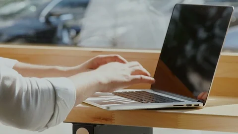 Man's arms typing on computer near the window Video stock 112988282