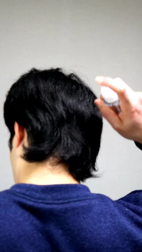 A man's back as he pours water on his hair. Stock Footage 336223992