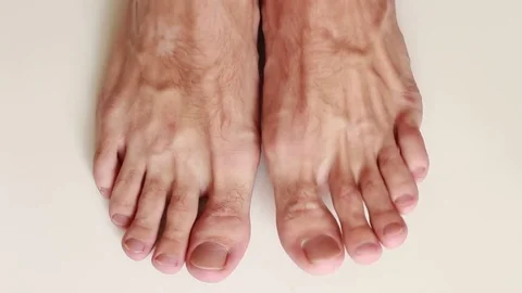 Man's barefeet on white surface closeup 動画素材 79343660
