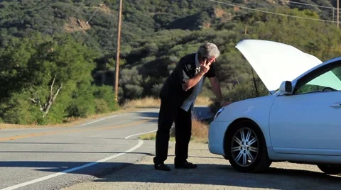 MANS CAR BREAKS DOWN ON ROAD Stock Footage 941627
