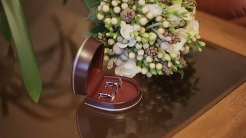 Mans cufflinks on white table. Stock Footage 69879554