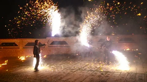 Mans dancing passionate dance with fire fan in his hand. Fire show Stock Footage 66201924