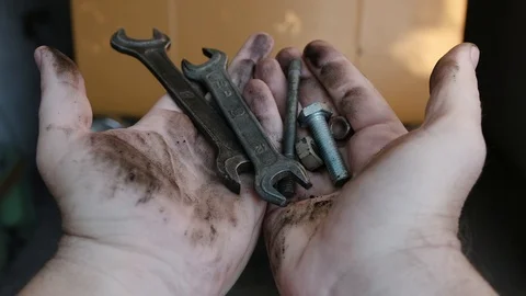 Man's dirty hands hold various tools and then drop them Stock Footage 91329649