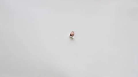 Mans eye peeking through a hole in white paper Stock Footage 68893909