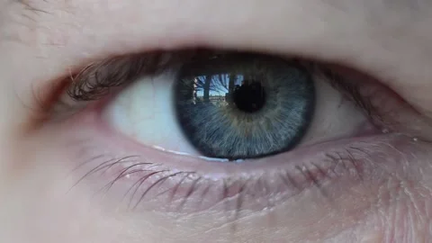The man's eye is very large. Vision blinking closing and opening thunderstorm. Video stock 153955376
