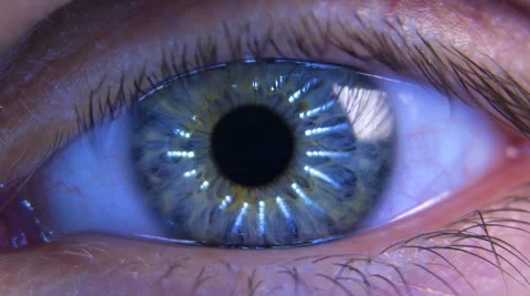 The man's eyes reflect the moving light rays  with zoom Stock Footage