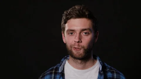 Man's Face Against a Black Background Stock Footage 88416622