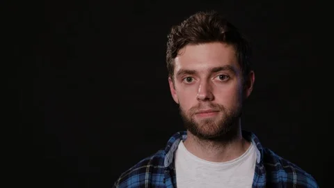 Man's Face Against a Black Background Stock Footage 88416763