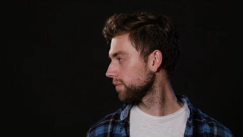 Man's Face Against a Black Background Stock Footage 88417008