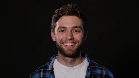 Man's Face Against a Black Background Stock Footage 88436740