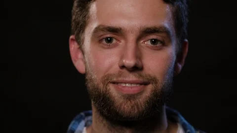 Man's Face Against a Black Background Stock Footage 88452743