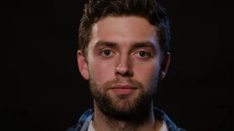 Man's Face Against a Black Background Stock Footage 88452889