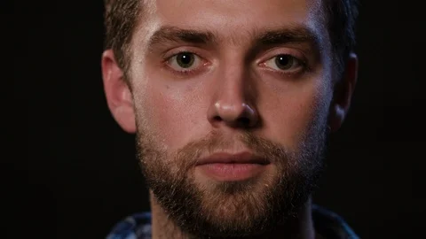 Man's Face Against a Black Background Stock Footage 88463259