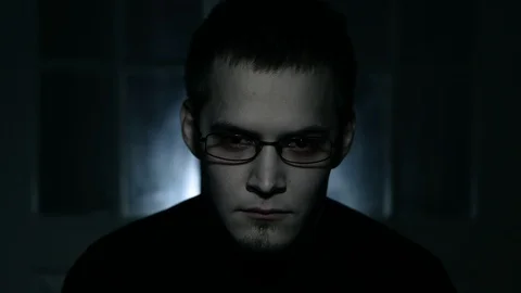 The man's face appears out of the darkness. Depression. Isolated. Paranoic Stock Footage 88949949