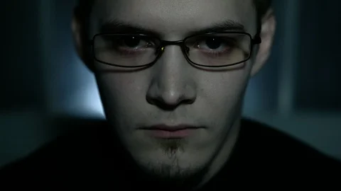 The man's face appears out of the darkness. Depression. Isolated. Paranoic Stock Footage 88950020